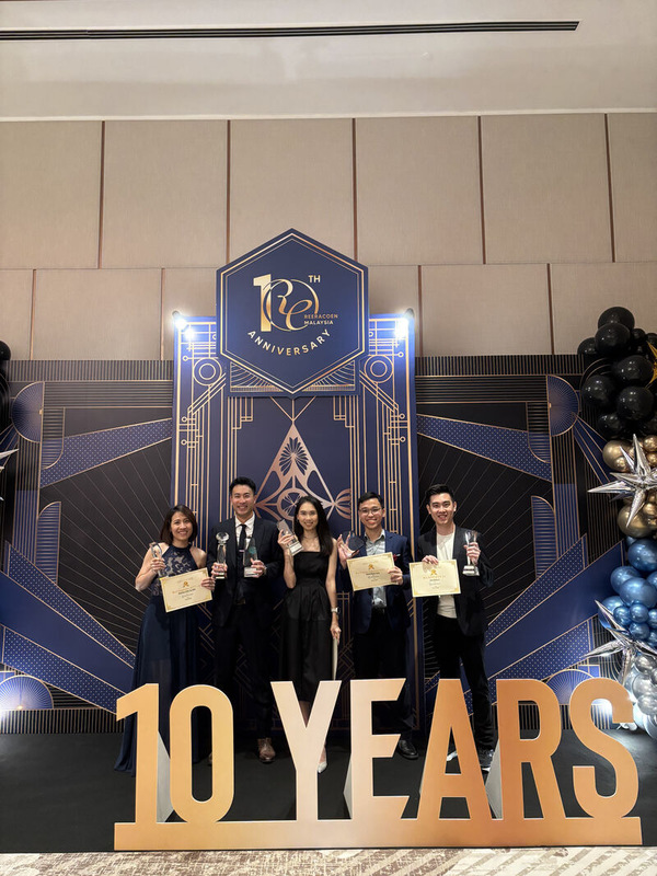 Cherlyn and fellow award winners holding trophies at the Reeracoen Malaysia 10th anniversary celebration